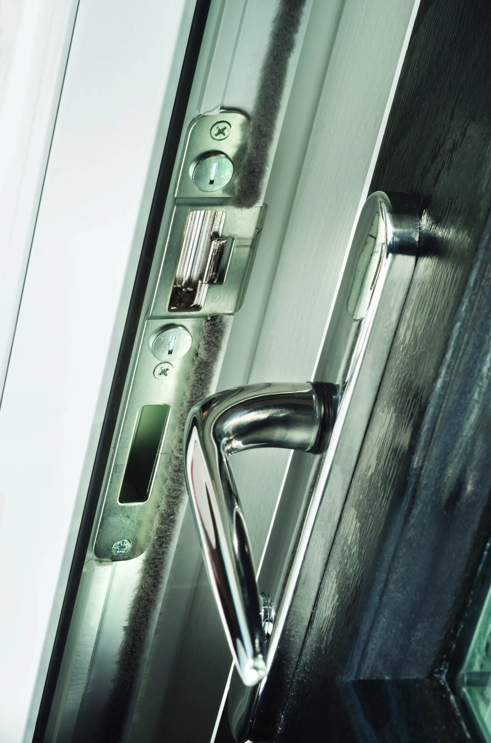Chrome handle and multi-point lock on the edge of an open composite door