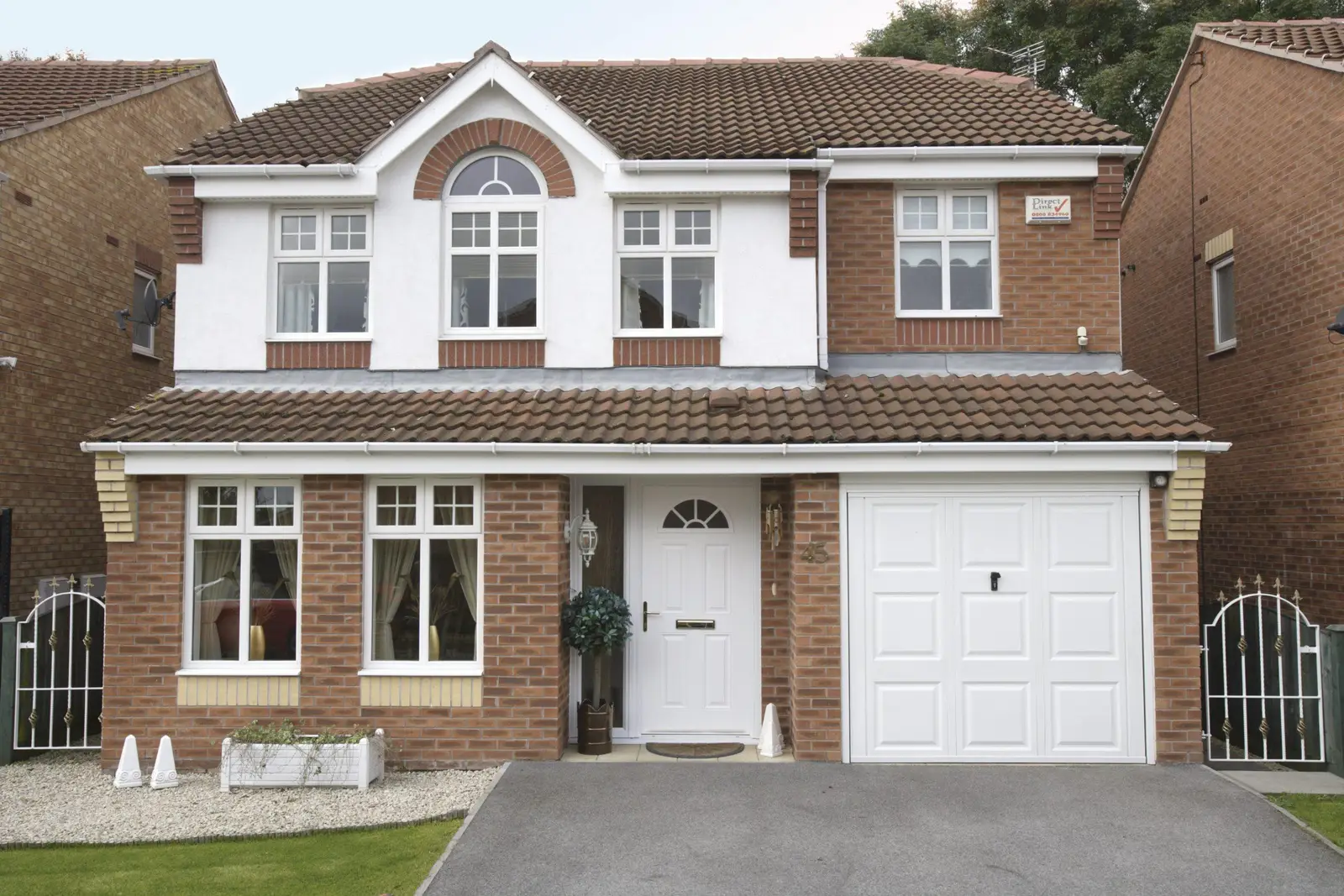 Detached family home with a white composite door and integral garage